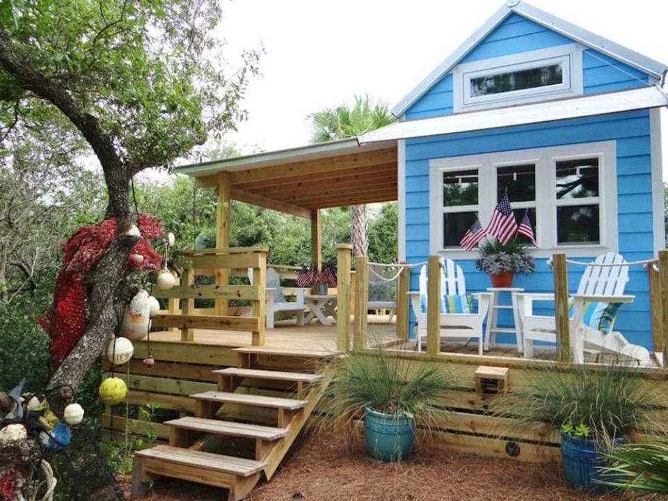 <p>This tiny beach cottage on Florida's St. George Island is called "Our Little Secret" by its owners. Small in size, it's mighty in design: Its coastal-cracker exterior is made of a Structured Insulated Paneling System built to withstand hurricane-force winds, while its <a href="http://tinyhouseswoon.com/st-george-island-tiny-house/#more-7927" rel="nofollow noopener" target="_blank" data-ylk="slk:cheery interior;elm:context_link;itc:0;sec:content-canvas" class="link ">cheery interior</a> features beadboard walls and ceilings and bamboo floors. Including the loft space, the 325-square-foot cottage sleeps two to four people, while a generous deck expands the living space into the outdoors for a perfect vacation retreat.</p><p><a class="link " href="https://www.facebook.com/ourlittlesecretbythesea" rel="nofollow noopener" target="_blank" data-ylk="slk:SEE INSIDE;elm:context_link;itc:0;sec:content-canvas">SEE INSIDE</a></p>