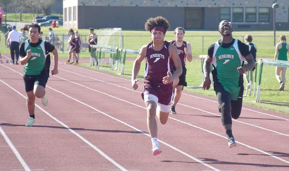 Frankfort-Schuyler freshman Lionell Coulthurst (center) pulls past Herkimer Magician Sunnah Maddox (right) on his way to a win in the 100-meter dash Monday. Coulthurst also won the 200-, 400- and 800-meter races at the meet.