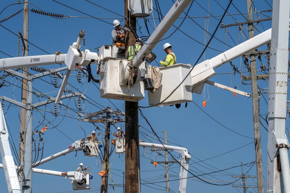 Workers from Entergy repair damaged power lines after Hurricane Zeta in 2020.