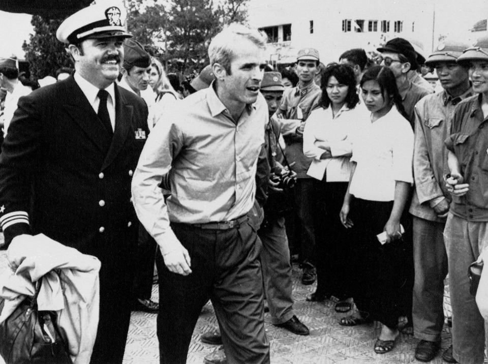 <p>McCain is escorted by Lt. Cmdr. Jay Coupe Jr. on March 14, 1973, to Hanoi's Gia Lam Airport after his release. </p>