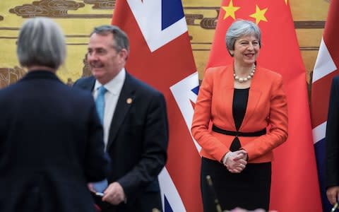 Theresa May and Liam Fox in Beijing, China - Credit: Bloomberg