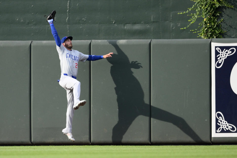 Chicago Cubs center fielder Cody Bellinger (24) makes a catch on a fly ball by Baltimore Orioles' Gunnar Henderson for the out during the first inning of a baseball game Tuesday, July 9, 2024, in Baltimore. (AP Photo/Nick Wass)