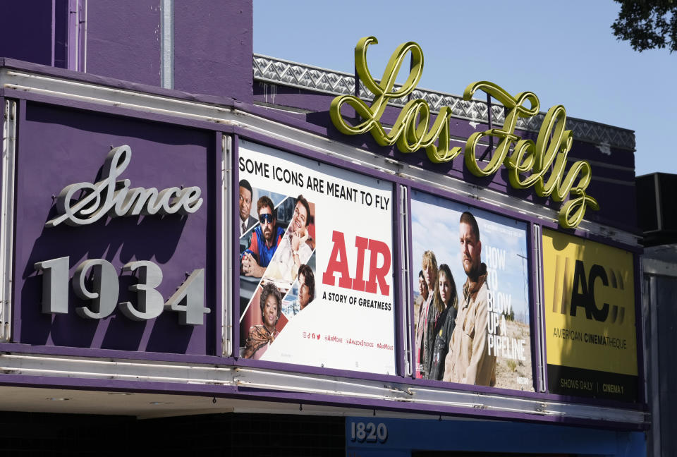 Poster art for the Amazon Studios film "Air" is displayed on the marquee of the Los Feliz Theater, Wednesday, April 19, 2023, in Los Angeles. Amazon Studios plans to release 12 to 15 movies theatrically every year, and Apple is set to spend $1 billion a year on movies that will land in cinemas before streaming. (AP Photo/Chris Pizzello)