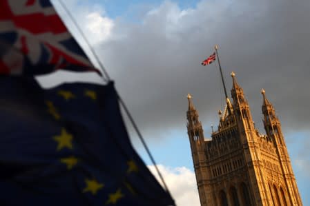 Flags flutter outside the Houses of Parliament, in London