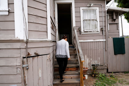 Sandra Gutierrez, who fled from gang violence in Honduras with her family and was granted asylum by the United States in 2016, walks into her home in Oakland, California, U.S., May 30, 2017. Picture taken May 30, 2017. REUTERS/Stephen Lam