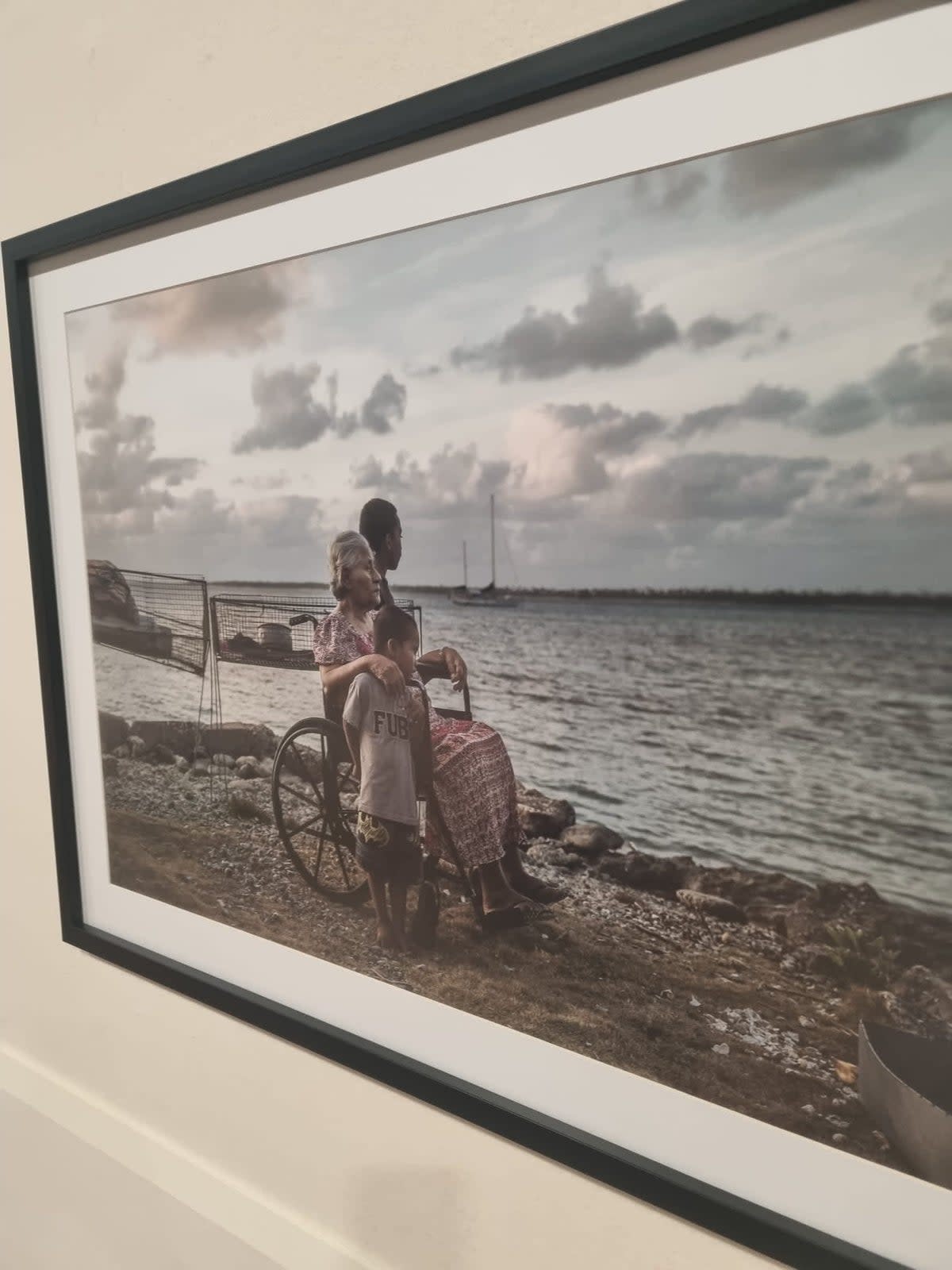 The photo of Theresa de Brun, Tina Stege’s great aunt, and her grandchildren on display inside the Cop28 venue. The image bears witness to the scale of the erosion caused by sea level rise on the remote outer island of Likiep in the Marshall Islands (Tina Stege)