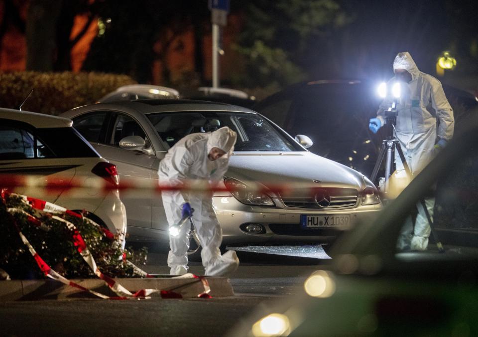 Forensics investigate the scene after a shooting in central Hanau, Germany Thursday, Feb. 20, 2020. Eight people were killed in shootings in the German city of Hanau on Wednesday evening, authorities said. (AP Photo/Michael Probst)