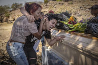 <p>Darwin mourns the death of his brother Marco at his funeral. His brother, 28, was gay and was kidnapped, tortured and killed. (Photo: Francesca Volpi) </p>