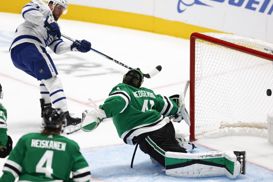 Toronto Maple Leafs defenseman Morgan Rielly (44) shoots the puck past Dallas Stars goaltender Scott Wedgewood (41) for a goal during the first period of an NHL hockey game Thursday, Oct. 26, 2023, in Dallas. (AP Photo/Brandon Wade)