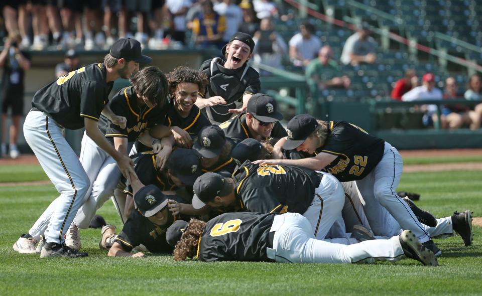 Greece Athena celebrate in a pile of players near the pitchers mound after the final out giving them the Section V Class A1 Championship game win over Churchville-Chili 11-4, Saturday, May 27, 2023 at Innovative Field in Rochester.