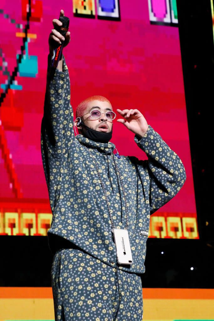 <p>Formally known as Benito Antonio Martínez Ocasio, Bad Bunny came on to the Latin trap scene after being <a href="https://www.billboard.com/articles/columns/latin/8343841/bad-bunny-video-interview" rel="nofollow noopener" target="_blank" data-ylk="slk:discovered on SoundCloud;elm:context_link;itc:0;sec:content-canvas" class="link ">discovered on SoundCloud</a> with his song "<a href="https://www.amazon.com/Diles-feat-Arcangel-Nengo-Explicit/dp/B01L0PH87Q?tag=syn-yahoo-20&ascsubtag=%5Bartid%7C10063.g.34123558%5Bsrc%7Cyahoo-us" rel="nofollow noopener" target="_blank" data-ylk="slk:Diles;elm:context_link;itc:0;sec:content-canvas" class="link ">Diles</a>." The 26-year-old Puerto Rican wrote, produced, and sang original music while <a href="https://www.bostonherald.com/2020/03/02/how-bad-bunny-went-from-grocery-bagger-to-rap-star/" rel="nofollow noopener" target="_blank" data-ylk="slk:bagging groceries at a supermarket;elm:context_link;itc:0;sec:content-canvas" class="link ">bagging groceries at a supermarket</a> in Vega Baja, Puerto Rico. Since then, he's collaborated with <strong>Drake</strong>, <strong>Cardi B</strong>., and <strong>Nicki Minaj</strong>. Not to mention, he's been <a href="https://www.grammy.com/grammys/artists/bad-bunny/243129" rel="nofollow noopener" target="_blank" data-ylk="slk:nominated three times;elm:context_link;itc:0;sec:content-canvas" class="link ">nominated three times</a> for a Grammy and performed at the 2020 Super Bowl Halftime show.</p>