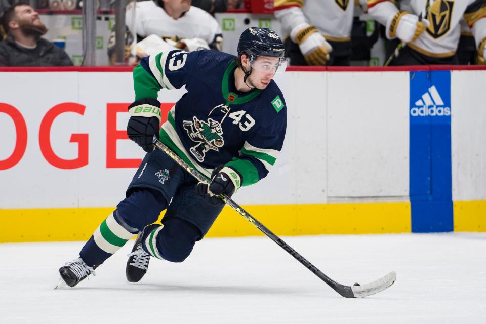 Vancouver Canucks defenseman Quinn Hughes (43) handles the puck  against the Vegas Golden Knights in the second period at Rogers Arena on Nov. 21, 2022.