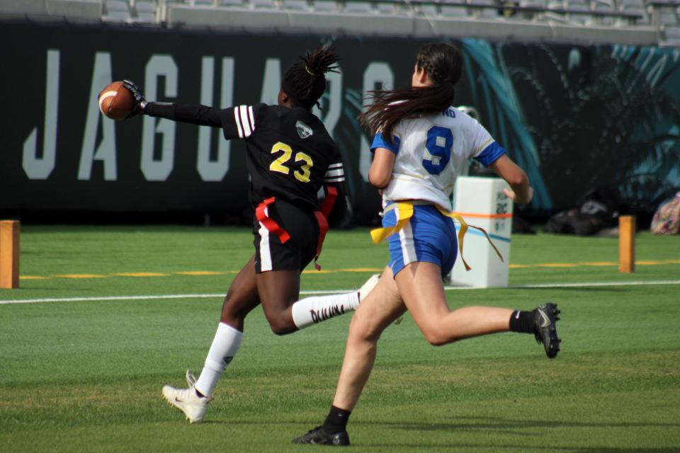 White receiver Tremesha Harris (23) races to the end zone for a touchdown against Daytona Beach Mainland in the Jaguars Prep Girls Flag Football Preseason Classic at TIAA Bank Field on Monday.