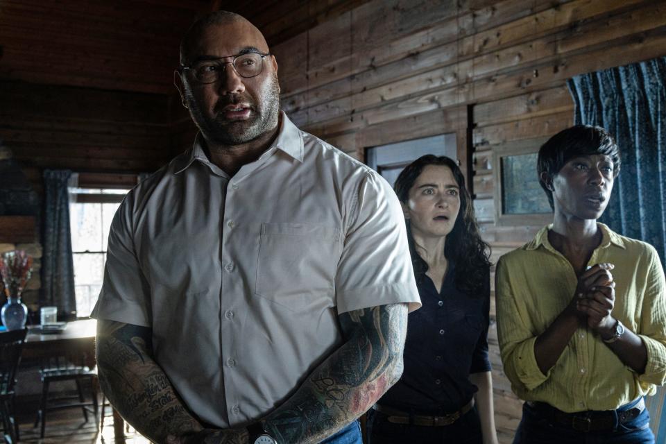 Dave Bautista standing in a cabin