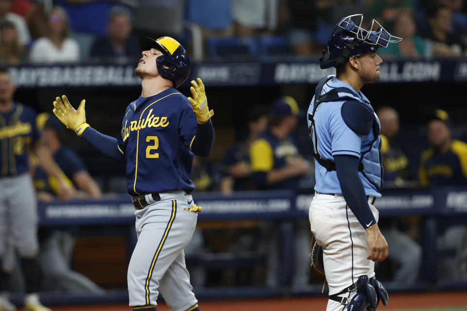 Tampa Bay Rays catcher Rene Pinto stands at home plate as Milwaukee Brewers' Luis Urias reacts after hitting a home run during the sixth inning of a baseball game Tuesday, June 28, 2022, in St. Petersburg, Fla. (AP Photo/Scott Audette)