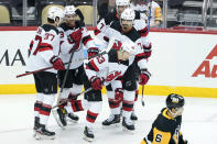 New Jersey Devils' Jesper Bratt (63) celebrates with teammates after scoring his second goal against the Pittsburgh Penguins during the first period of an NHL hockey game, Thursday, Feb. 24, 2022, in Pittsburgh. (AP Photo/Keith Srakocic)