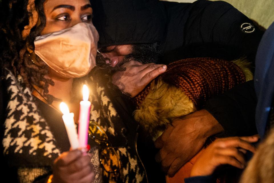 Family members console each other at a vigil  Thursday, Jan. 6, 2022 to honor the victims of a rowhouse fire in Philadelphia. The family on Vanessa McDonald was lost in the fire including her three daughters and nine grandchildren.