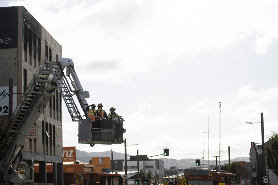 Investigators survey the scene Wednesday, May 17, 2023, after an apartment fire at Loafers Lodge in Wellington, New Zealand. A fire ripped through the hostel in New Zealand's capital Tuesday, killing multiple people and forcing others to flee the four-story building in their pajamas in what a fire chief called his "worst nightmare." (George Heard/New Zealand Herald via AP)