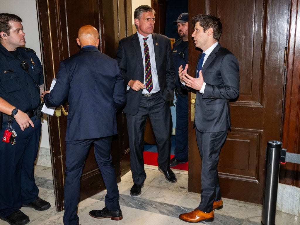 Sam Altman speaks to Democratic Sen. Martin Heinrich during a forum on AI in the Senate.