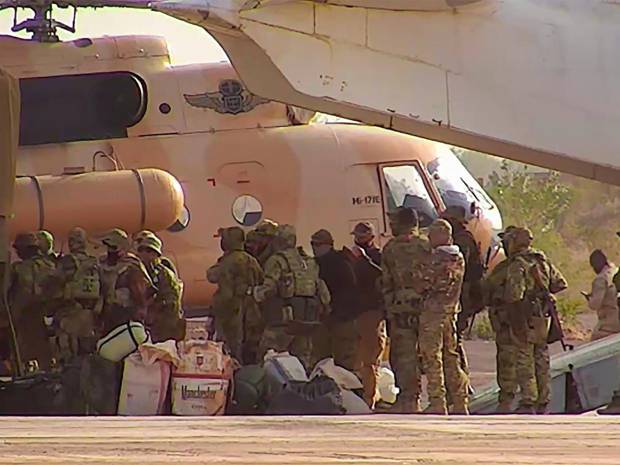 This undated photograph handed out by French military shows Russian mercenaries boarding a helicopter in northern Mali