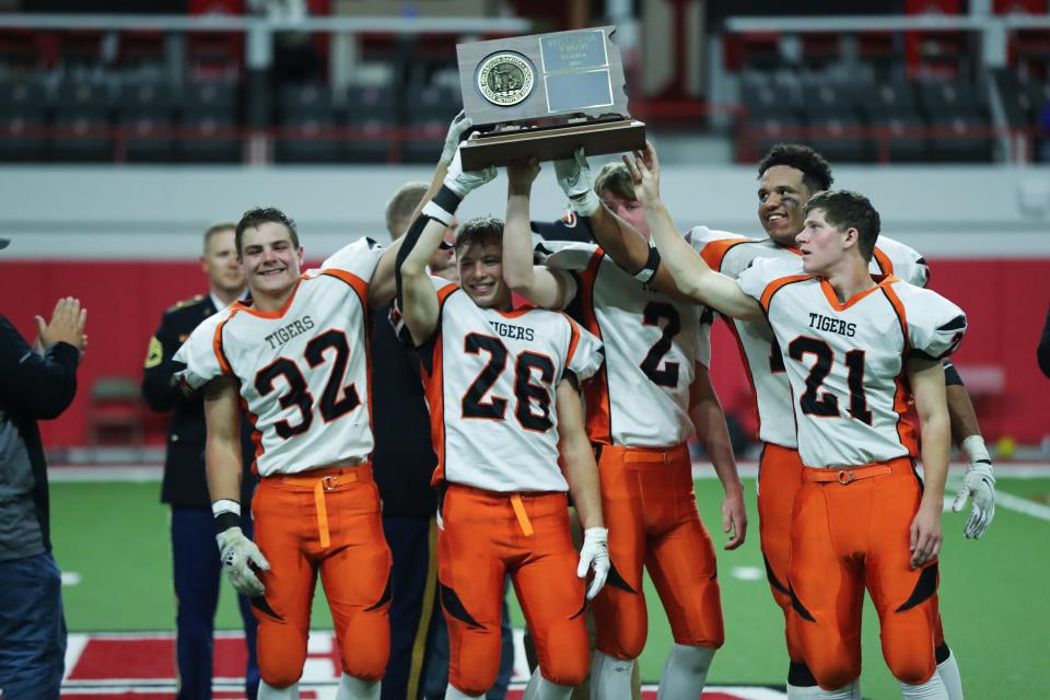 The Howard Tigers seniors celebrate their team's 9A State Championship Thursday at the Dakota Dome after defeating the Herreid/Selby Area 55-18.