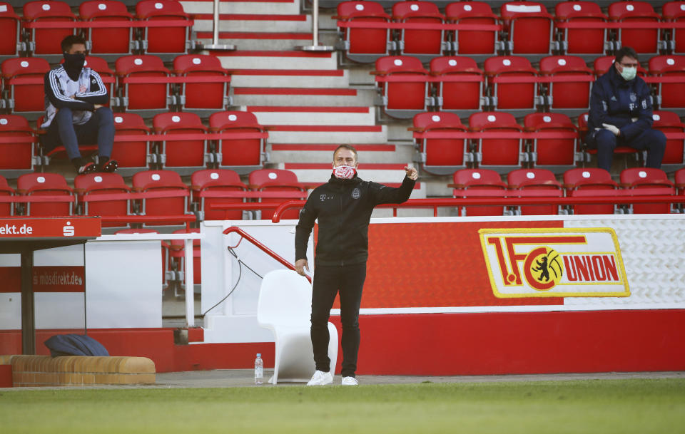 Coach Hansi Flick of Munich gestures during the German Bundesliga soccer match between Union Berlin and Bayern Munich in Berlin, Germany, Sunday, May 17, 2020. The German Bundesliga becomes the world's first major soccer league to resume after a two-month suspension because of the coronavirus pandemic. (AP Photo/Hannibal Hanschke, Pool)