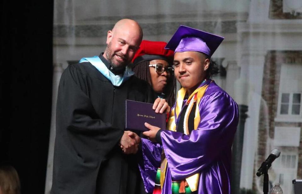 Jorge Luis Mendoza Rendón gets his diploma from school board member Andrew Levine during the Fresno High graduation ceremony held at the Save Mart Center on June 5, 2023.