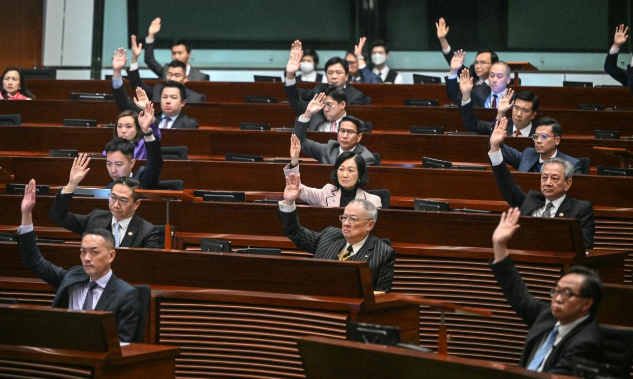 <span>Hong Kong lawmakers passed new measures to quash dissent unanimously on Tuesday.</span><span>Photograph: Peter Parks/AFP/Getty Images</span>