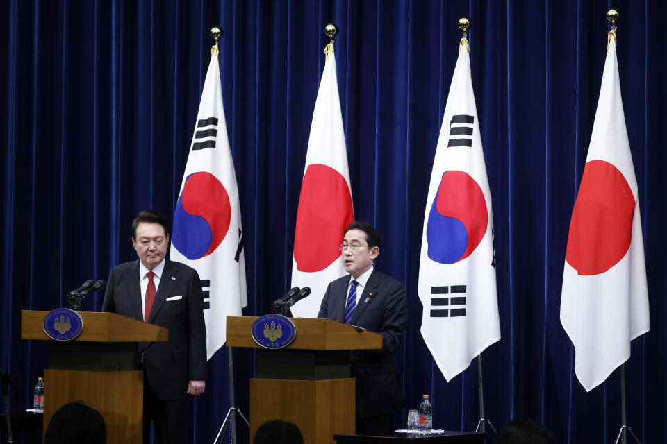 South Korean President Yoon Suk Yeol, left, listens to Japanese Prime Minister Fumio Kishida, right, during a joint news conference at the prime minister's official residence in Tokyo, Japan, Thursday, March 16, 2023. (Kiyoshi Ota/Pool Photo via AP)