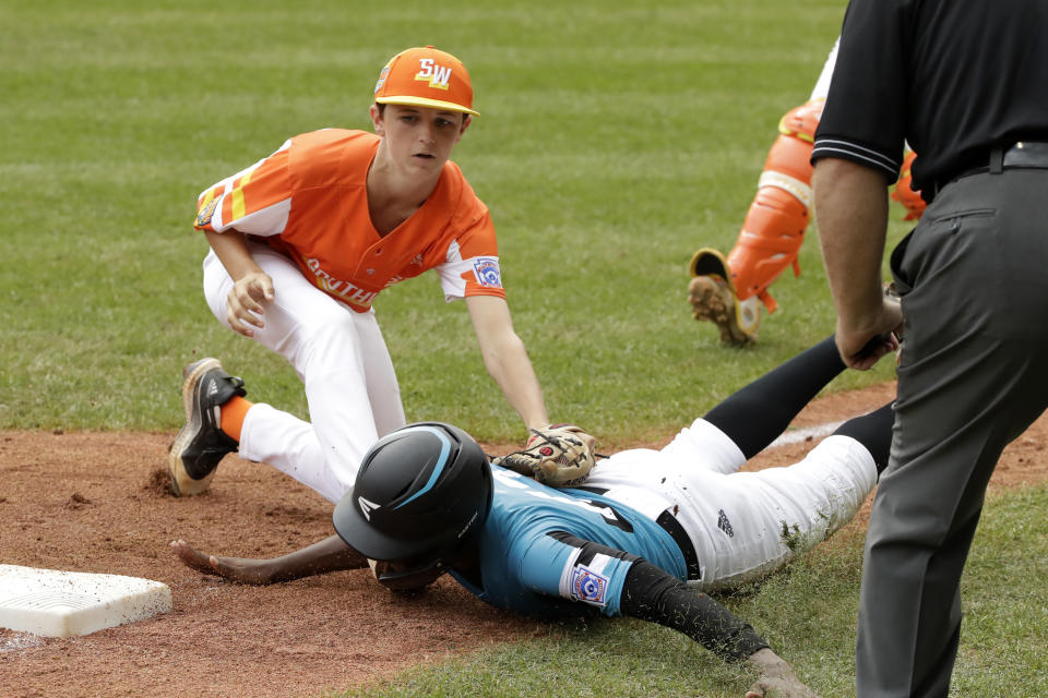 River Ridge, Louisiana's Marshall Louque, top, tags out Curacao's Jurdrick Profar (13) who was trying to dive back to third base during the third inning of the Little League World Series Championship game in South Williamsport, Pa., Sunday, Aug. 25, 2019. (AP Photo/Gene J. Puskar)