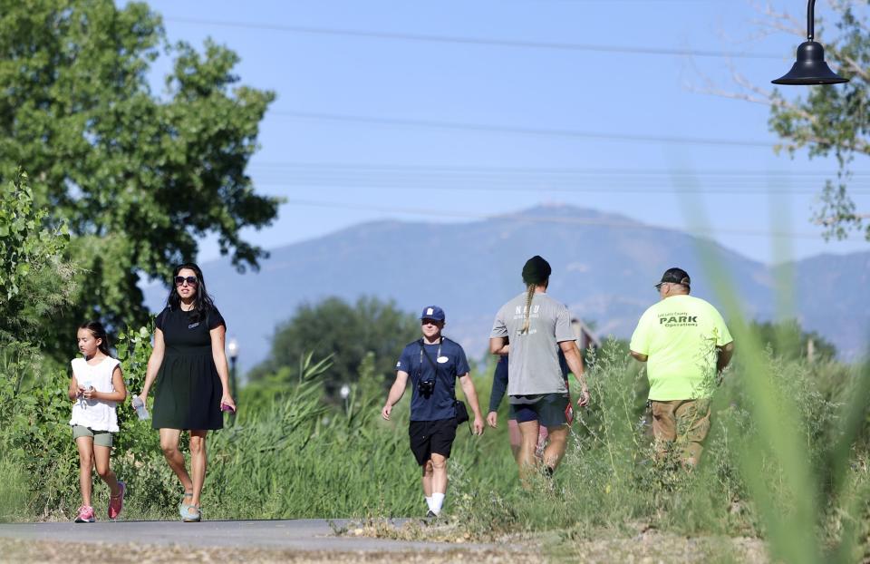 People walk in Pioneer Crossing Regional Park in West Valley on Thursday, July 20, 2023. | Laura Seitz, Deseret News