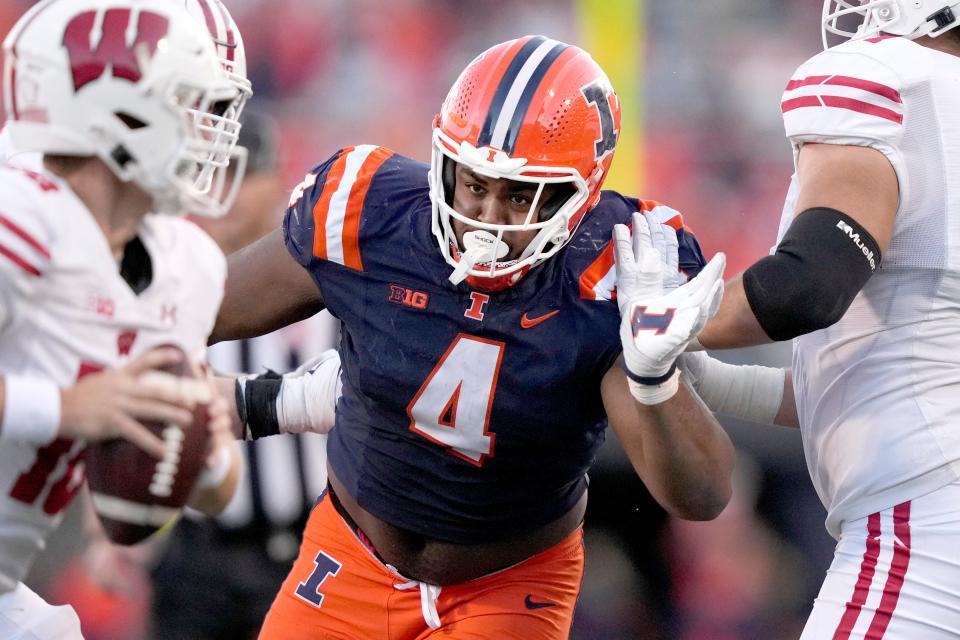 FILE - Illinois defensive lineman Jer'Zhan Newton rushes the quarterback during an NCAA college football game against Wisconsin, Saturday, Oct. 21, 2023, in Champaign, Ill. (AP Photo/Charles Rex Arbogast, File)