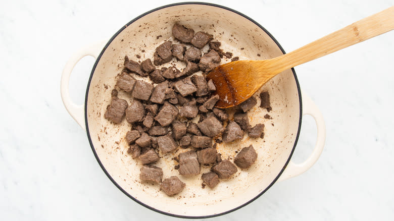 Beef chunks browning in casserole pot