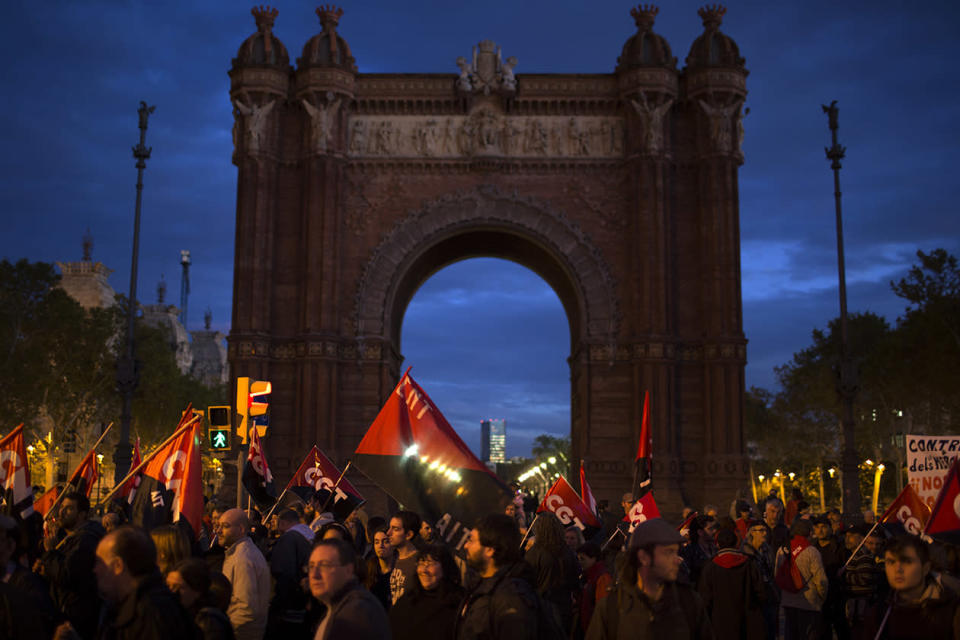 Demonstrators walk past the Arch of Triumph as they march during a protest in Barcelona.