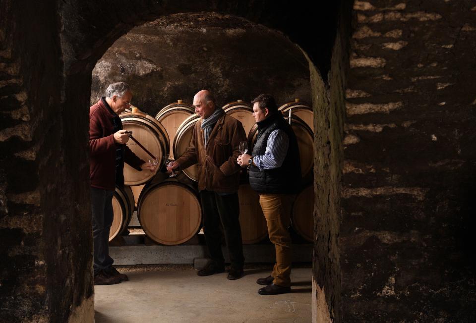 Leading figure of the Burgundy winegrowers, co-heir and co-manager of the estate of La Romanee Conti, Aubert de Villaine (C), his nephew Bertrand de Villaine (R) and chief of the cellars Bernard Noblet taste wine in a cellar on January 9, 2018 in Vosnes Romanee (Burgondy).  / AFP PHOTO / Eric FEFERBERG        (Photo credit should read ERIC FEFERBERG/AFP/Getty Images)