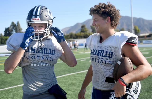 Wide receiver Griffin Addison, left, talks with quarterback Brody Meyer before a Camarillo High football team practice on Tuesday, Oct. 18, 2022. The duo has connected 51 times for 1,075 yards this season.