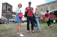 BERLIN, GERMANY - JULY 21: Attendees wait for the start of the games at the second annual Hipster Olympics on July 21, 2012 in Berlin, Germany. With events such as the "Horn-Rimmed Glasses Throw," "Skinny Jeans Tug-O-War," "Vinyl Record Spinning Contest" and "Cloth Tote Sack Race," the Hipster Olympics both mocks and celebrates the Hipster subculture, which some critics claim could never be accurately defined and others that it never existed in the first place. The imprecise nature of determining what makes one a member means that the symptomatic elements of adherants to the group vary in each country, but the archetype of the version in Berlin, one of the more popular locations for those following its lifestyle, along with London and Brooklyn, includes a penchant for canvas tote bags, the carbonated yerba mate drink Club Mate, analogue film cameras, asymetrical haircuts, 80s neon fashion, and, allegedly, a heavy dose of irony. To some in Berlin, members of the hipster "movement" have replaced a former unwanted identity in gentrifying neighborhoods, the Yuppie, for targets of criticism, as landlords raise rents in the areas to which they relocate, particularly the up-and-coming neighborhood of Neukoelln. (Photo by Adam Berry/Getty Images)