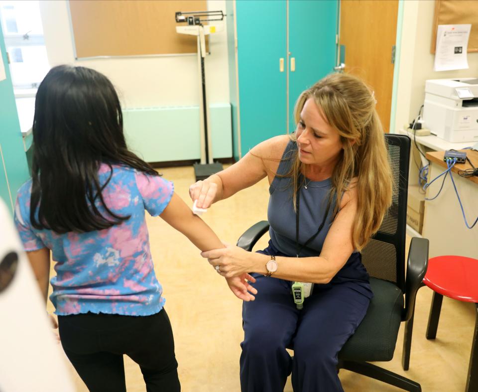 Colleen Panetta, R.N. helps a student with an elbow scrape in her office at the Church Street School in White Plains, Oct. 3, 2023.