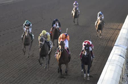 Nov 4, 2016; Santa Anita, CA, USA; Gary Stevens aboard Beholder races alongside Mike Smith aboard Songbird to the finish line in race nine during the 2016 Breeders Cup Championships at Santa Anita Park. Mandatory Credit: Richard Mackson-USA TODAY Sports - RTX2RZXV