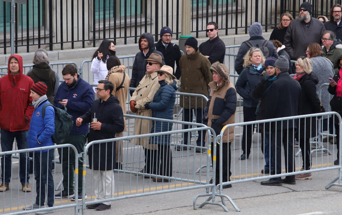 Members of the public line up outside to pay their respects to former prime minister Brian Mulroney as he lies in state at the Sir John A. Macdonald Building, across from Parliament Hill in Ottawa on Tuesday, March 19, 2024. THE CANADIAN PRESS/ Patrick Doyle