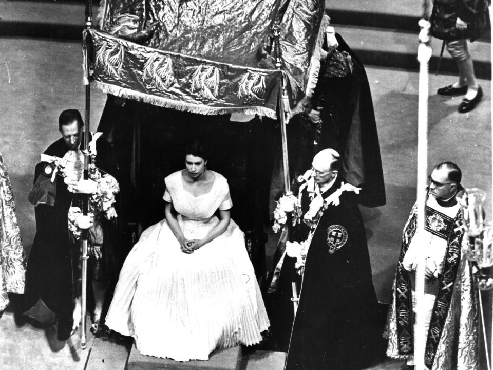 The Pall of Cloth of Gold is held over Queen Elizabeth II.