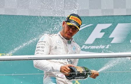 Germany Formula One - F1 - German Grand Prix 2016 - Hockenheimring, Germany - 31/7/16 - Mercedes' Lewis Hamilton sprays champagne after the race. REUTERS/Ralph Orlowski