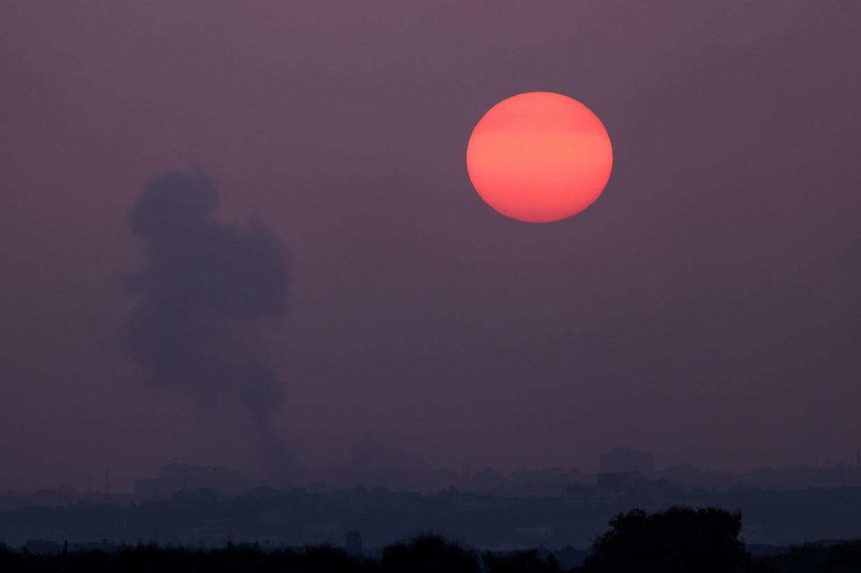 Smoke billows during a sunset over Gaza and Israel (AFP via Getty Images)