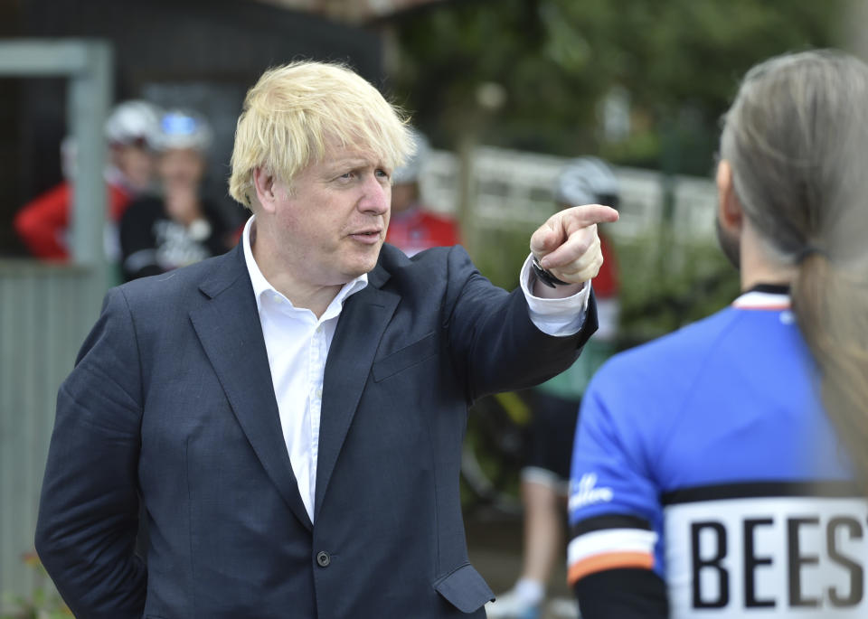 Britain's Prime Minister Boris Johnson, talks to cyclist Robert Cleave at the Canal Side Heritage Centre in Beeston near Nottingham, England, Tuesday, July 28, 2020. The government is launching a new cycling intuitive to help get people fitter. (AP Photo/Rui Vieira, Pool)