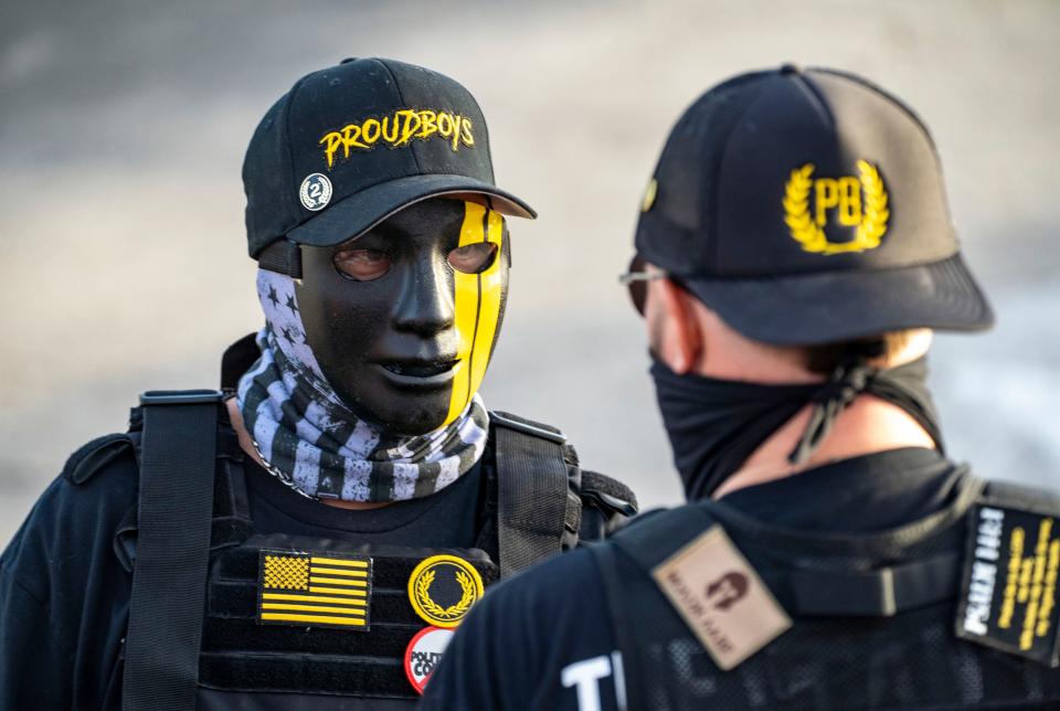 On the anniversary of the US Capitol riot attack, men dressed in Proud Boys attire attend a Trump rally in West Palm Beach.