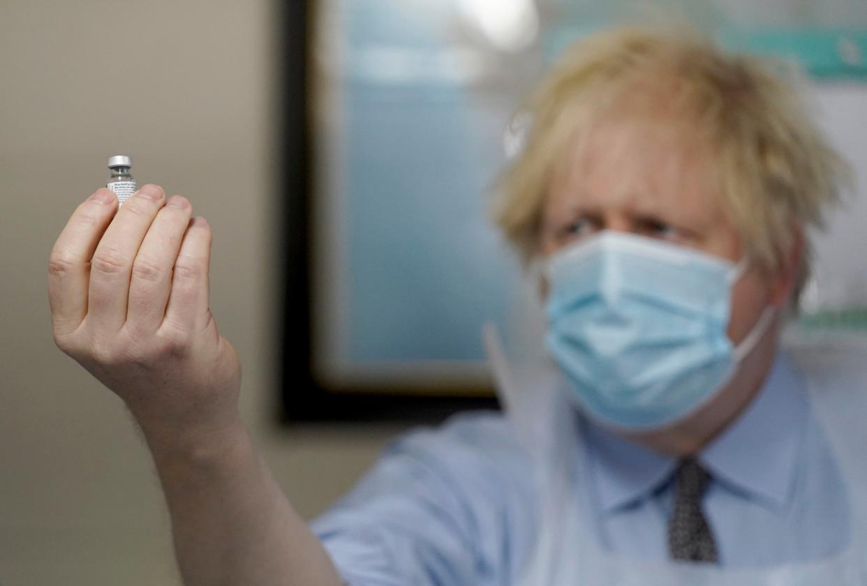 <p>Prime Minister Boris Johnson holds a bottle of the Pfizer BioNTech vaccine during a visit to a coronavirus vaccination centre in Batley, West Yorkshire</p> (Getty)