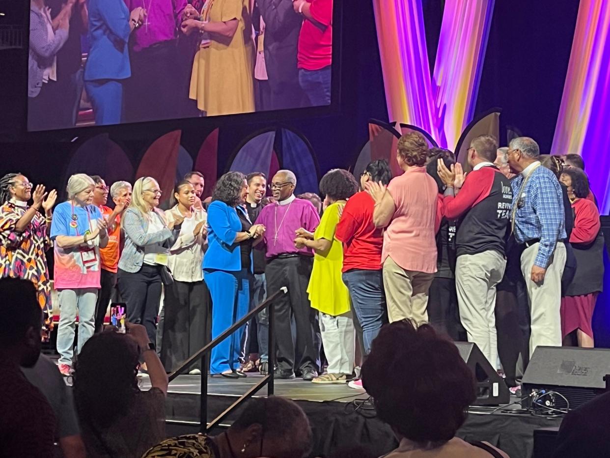 Rev. Michael Curry, presiding bishop and primate of The Episcopal Church surrounded by people on stage at the Episcopal Revival at the 81st General Convention on June 23, 2024