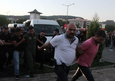 Soldiers suspected of being involved in the coup attempt are escorted by policemen as they arrive at a courthouse in the resort town of Marmaris, Turkey, July 17, 2016. REUTERS/Kenan Gurbuz