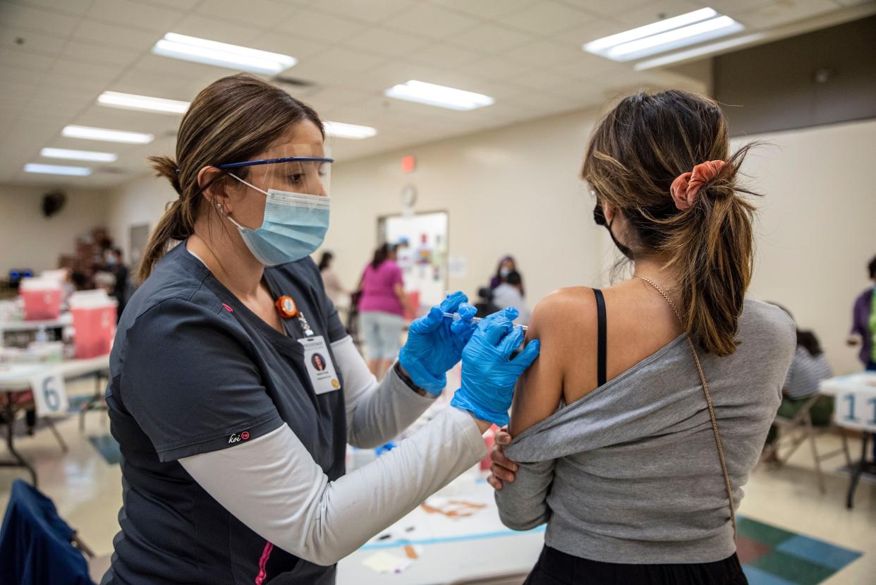 Jessica Flores gets her second dose of the Moderna COVID-19 vaccine at a vaccination site at a senior center on March 29, 2021, in San Antonio, Texas. Texas has opened up all vaccination eligibility to all adults starting today.