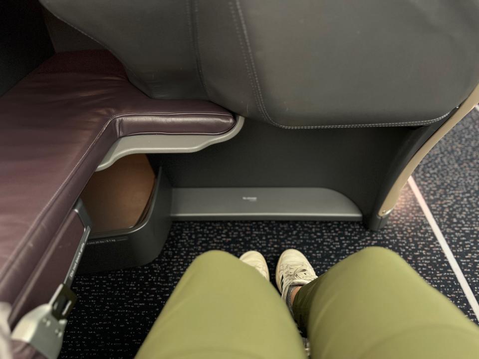 My legs stretched out in Singapore's A350 business class seat.
